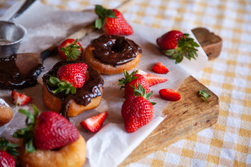 Homemade donuts with powdered sugar and strawberry 