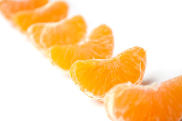 pieces of peeled tangerine alignment on white background