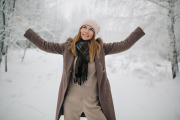 Fototapeta na wymiar Photo of happy blonde woman on walk in winter forest