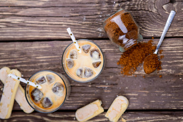 Iced iced coffee on a wooden table. Summer drinks.