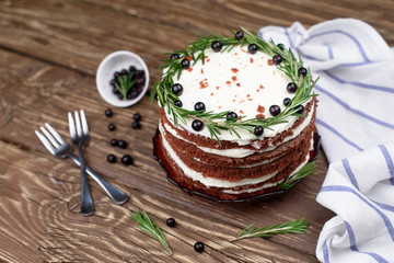  Chocolate cake with cream butter on a wooden table
