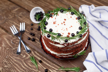  Chocolate cake with cream butter on a wooden table