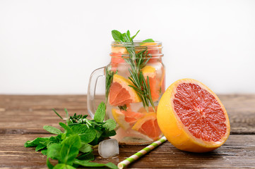  Lemonade with rosemary and grapefruit on a wooden table