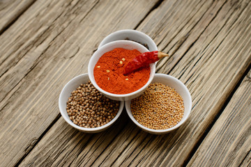  A set of spices on a wooden table.