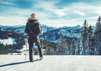 woman standing on top of mountain in snow