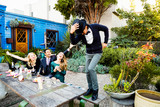 Man dancing on table at cocktail party