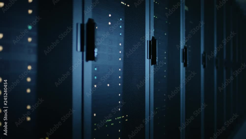 Fototapete Moving Walkthrough Shot of Dark Modern Data Center With Row of Fully Operational Server Racks. Modern Hi-Tech Concept for Cloud Computing, Artificial Intelligence, Supercomputer, Cybersecurity