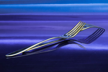 forks on metallic blue