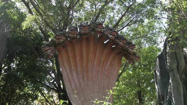 Rotating shot around Naga serpent in Vietnam between woodlands.