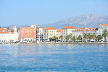  Morning view of city downtown centre from the tour boat. Old town with houses made of stones and orange sealing.