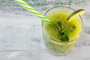 Green healthy smoothie. Kiwi fruit cocktail in a glass.
