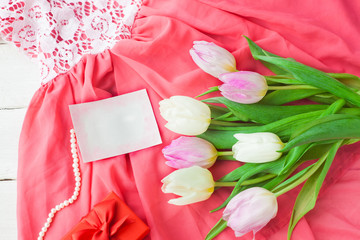 White and purple tulips and a gift in a red box on a white wooden background. Spring. International Women's Day. Valentine's Day. card ,Selective focus.