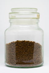 Closeup of instant coffee in a jar, isolated on a white background