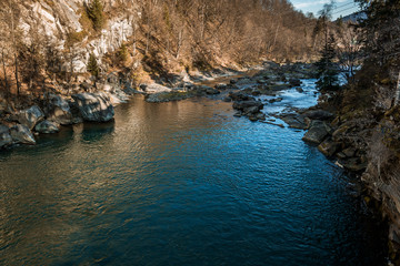 view of the river or lake surrounded by mountains and stones