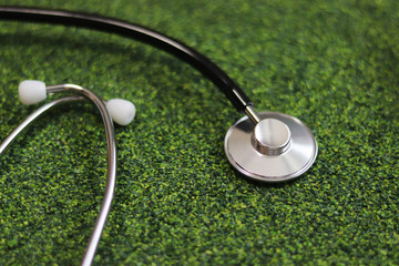 Stethoscope on the green background.