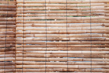 Bamboo arranged horizontally with black tie rope