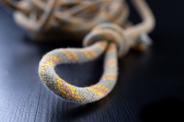 A knot tied on a sailing line. A rope for sailors and travelers on the table.