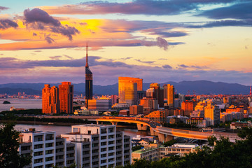 A sunset with a view of central Fukuoka, Japan, with tall modern buildings