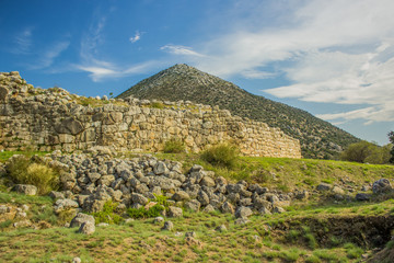 abandoned destroyed ancient site on beautiful spring scenic landscape with mountain background