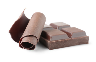 Yummy chocolate curl and piece on white background