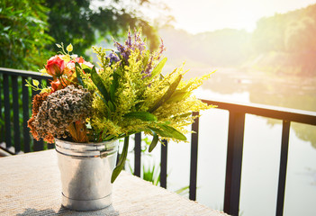 plant and flowers in pot - vase flowers on the table out balcony and sunlight in the morning