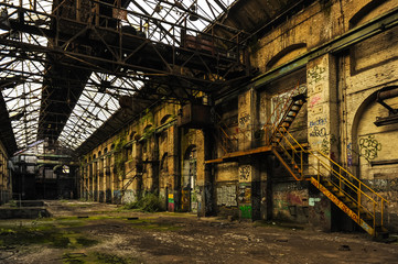Ruined long factory with glass roof