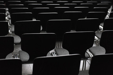 Black wooden chairs in rows