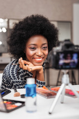 Smiling african american woman in an orange top feeling great