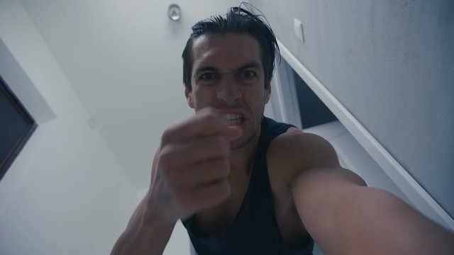 aggressive man screams hard and brutally beats lying opponent