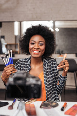Cute african american woman with curly hair making photo for fashion magazine