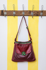 Leather bag hanging on a wardrobe