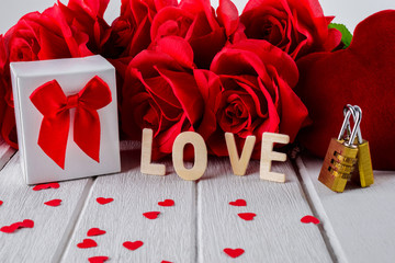Valentines background with red rose, Heart shape, Gift box, Wooden letters word "LOVE" and Couple Combination golden padlock