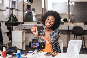 Beautiful dark-skinned woman with curly hair smiling brightly