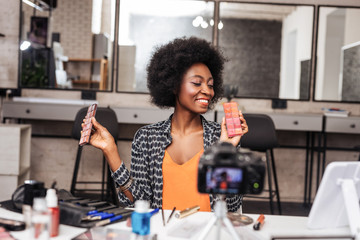 Beautiful dark-skinned model with curly hair showing new color palette