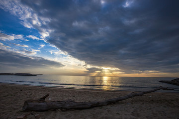 Obraz premium The natural background on the beach has golden light shining in the sea and has a beautiful blue sky, this beautiful natural event is not very frequent depending on the weather in each day.