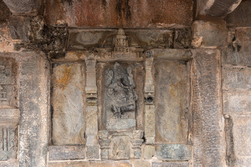 Belur, Karnataka, India - November 2, 2013: Chennakeshava Temple building. Stone statue of Ganesha, son of Lord Shiva. with well carrested trunk and legs.