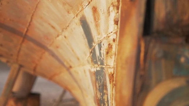 Beautiful old rustic sapele timber planks of carvel built boat hull sunset