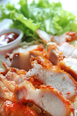 Fototapeta na wymiar Thai roasted pork (Char Siew) served with thai chili sauce and lettuce