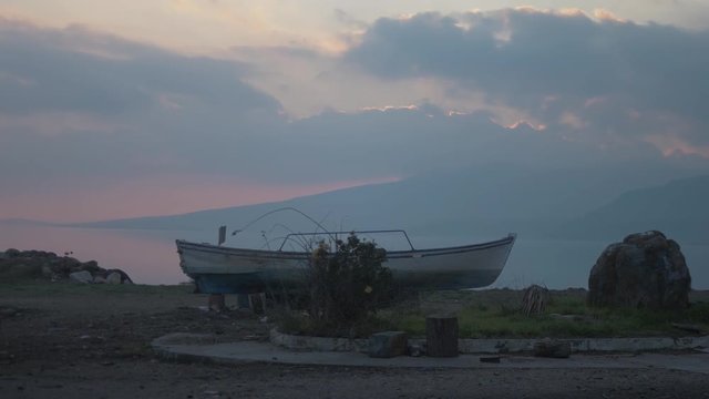 Scenic sunset landscape shot of small traditional fishing boat