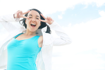woman smiling at the beach on a sunny day