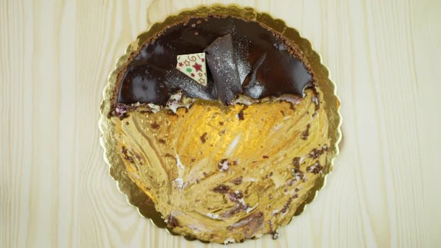 Chokolate cake eaten by itself. Sloppy bites, stop motion. View from above.