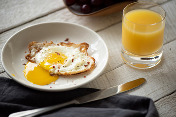 breakfast with fried eggs and orange juice