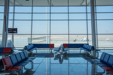 Airport terminal interior with rows of empty seats