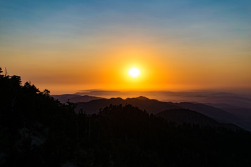 Bright orange sunset over California mountain peaks