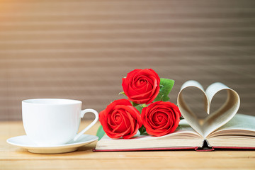 Page of book curved  heart shape and red rose