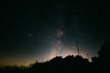 Milky Way over telephone wires on a remote road