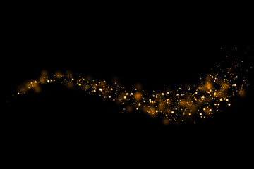 Gold glitter particles lights trail and bokeh on a black background. Abstract line sparkle texture. © kaisorn