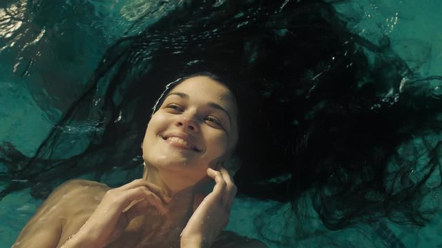 Portrait Of A Woman With Long Hair In Water