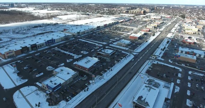 Aerial View Of Shopping Strip Mall Complex In Winter Time With Snow