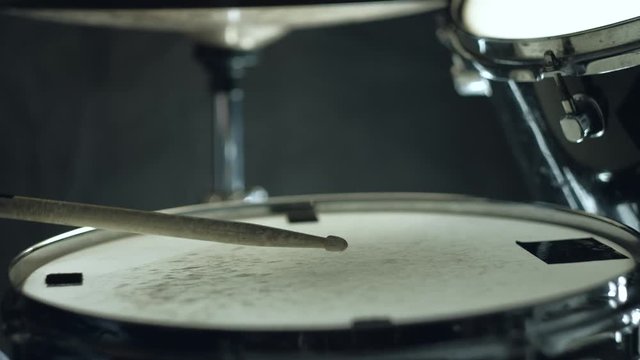 Jazz drummer playing at drums set on concert isolated on black background. 4k. Close up shot.